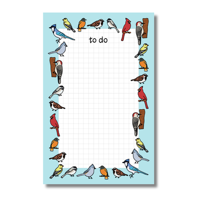 Notepad with colorful bird illustrations on a blue background
