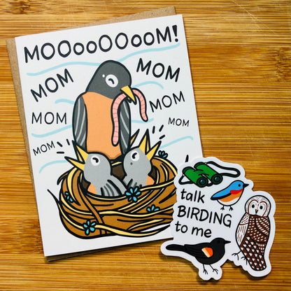 A bird-themed Mother's Day card and a 'talk birding to me' sticker photographed against a wood background.